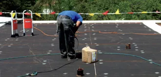 Step 1 - RhinoBond® plates are drilled through the insulation