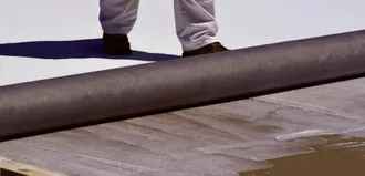 Step 2 - Membrane is rolled into adhesive while still wet